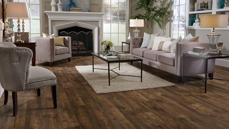 stunning dark stained wood look laminate flooring with realistic grains in a classic formal living space with a fireplace
